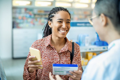 Woman discussing medication with pharmacist