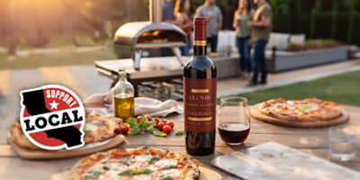 A bottle of J. Lohr wine next on table with pizza next to it with a support local California logo