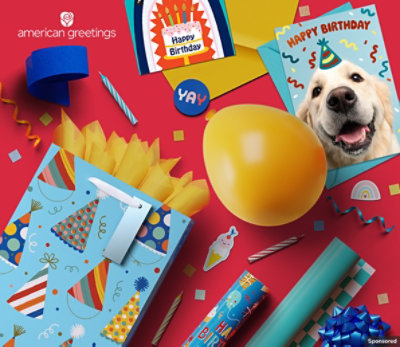 Birthday cards, gift packaging and an inflated balloon sit on a red background.