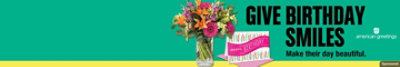 Bouquet of flowers next to a happy birthday card. Give birthday smiles. Make their day beautiful.