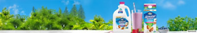 Picture of Almond Breeze Products against blue sky and green plants.