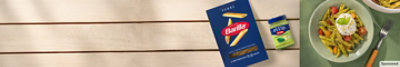 Barilla® Pasta box and Barilla® Pesto bottle on wooden background next to pasta dish image. 