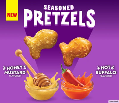 Goldfish Seasoned Pretzels on a purple background next to honey mustard and hot buffalo sauces.