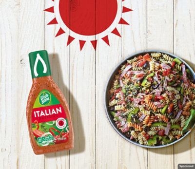 A bowl of Mediterranean Pasta Salad with a bottle of Wish-Bone salad dressing.