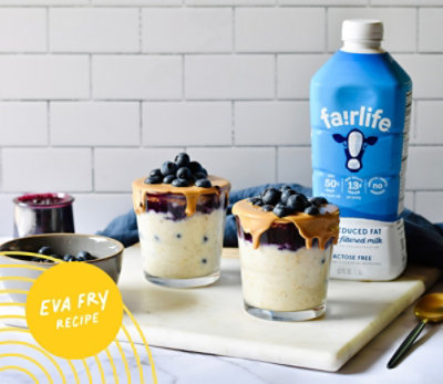 Cups of Blueberry Oatlmeal Overnight Oats next to bottle of Fairlife milk.