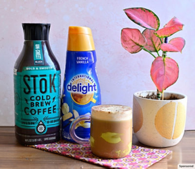 International Delight and SToK products with a coffee drink and potted plant.