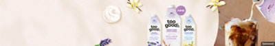 Three bottles of Too Good & Co creamer with iced coffee and vanilla and lavender flowers.
