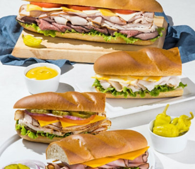 Fresh baked bread, sandwiches with deli meat, sides and condiments
