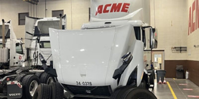 Safeway Carrs freight truck parked in a mechanics garage.