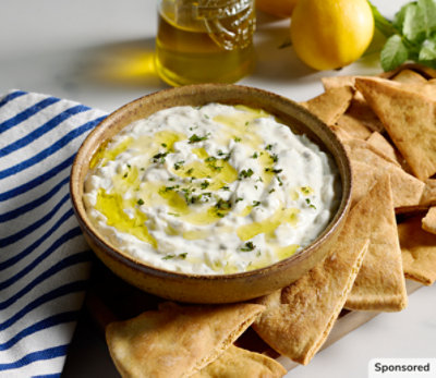 Image of tzatziki dip with olive oil and serve with toasted pita bread.