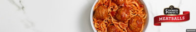 A bowl of spaghetti and Cooked Perfect Meatballs on a granite table background.