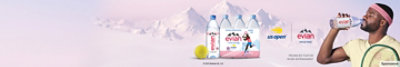 Francis Tiafoe drinking a bottle of evian water with the French Alps in the background.