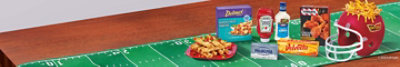 Football-themed game day spread with Delimex, Heinz, Philadelphia, Kraft, Velveeta,TGIF and Ore-Ida.