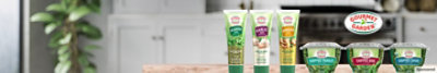 Gourmet Garden products lined up on a kitchen table
