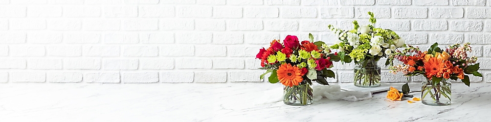 Colorful flowers in vases on a table