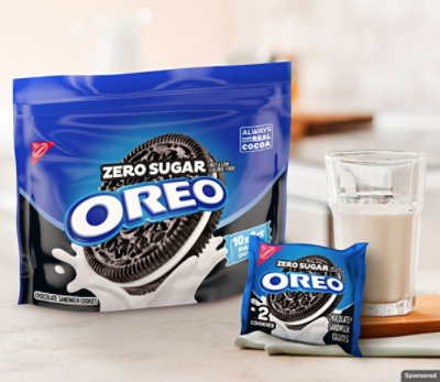 Zero Sugar OREO Cookies on a kitchen counter next to a glass of milk.