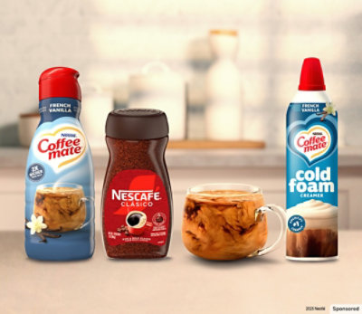 Packages of Necafe and Coffee mate lined up on a countertop.