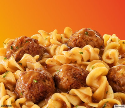 Pasta and meatballs on an orange background