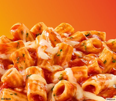 Cheesy pasta on an orange background