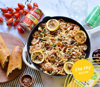 Pan of Mediterranean Pasta with Shrimp next to Hunt's Diced Tomatoes and bubly sparkling water.