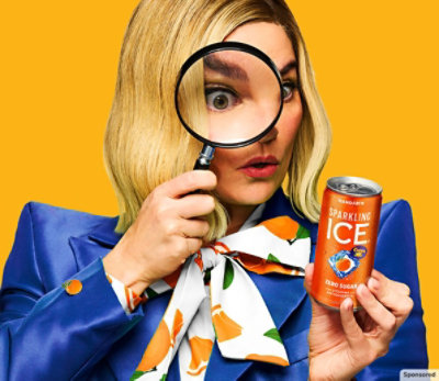 Chief Flavor Officer using a magnifying glass to look at a Sparkling Ice 7.5 oz Cuties Mandarin can.
