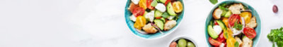 Fresh spring salad in two bowls on a table.