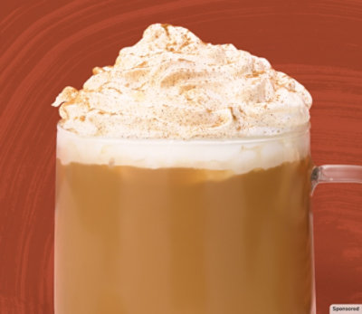 A mug of Starbucks pumpkin spice-flavored coffee on a fall-themed background.
