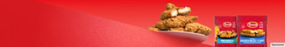 A plate of crispy chicken strips on red background.