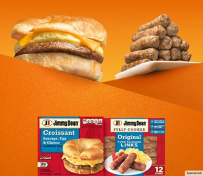 A delicious croissant sausage, egg and cheese sandwich next to a plate stacked with sausage links.