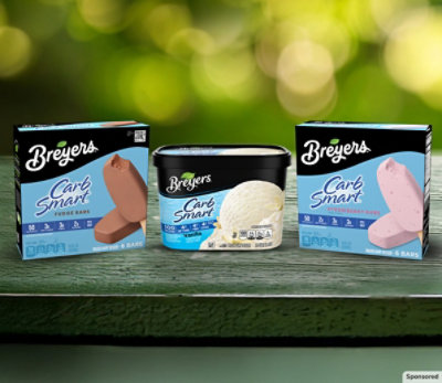 Three boxes of Breyers Carb Smart on green surface.