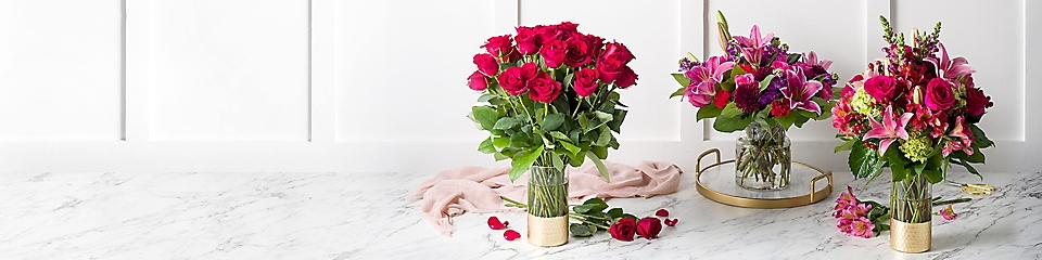 Red roses and mixed flower arrangements in vases