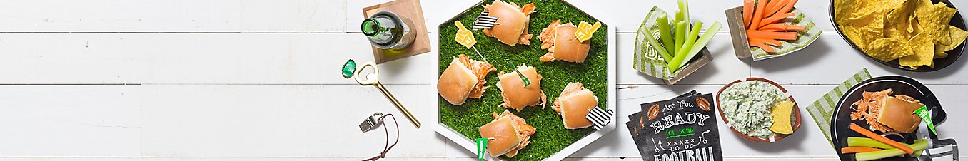Enjoy Game Day with sliders, chips and dip, celery and carrot sticks, and beer